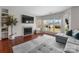 Bright living room with fireplace, large windows, and hardwood floors offers inviting atmosphere at 529 N Graham St # 2G, Charlotte, NC 28202