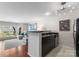 Open-concept kitchen with black countertops flows into the living area at 529 N Graham St, Charlotte, NC 28202