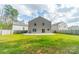 View of home's backyard featuring a lush lawn, privacy fence, and a gray two-story home at 5306 Graypark Dr, Charlotte, NC 28269