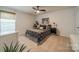 Well-lit bedroom featuring a cozy bed, a ceiling fan, and a window with blinds for privacy and comfort at 5306 Graypark Dr, Charlotte, NC 28269