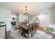 Spacious dining room with hardwood floors, modern decor, and a view of the kitchen at 5306 Graypark Dr, Charlotte, NC 28269