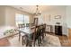 Formal dining room showcasing hardwood floors and a modern light fixture at 5306 Graypark Dr, Charlotte, NC 28269