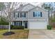 Two-story home featuring gray siding, black shutters, and a two-car garage at 5306 Graypark Dr, Charlotte, NC 28269