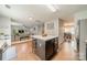 Open-concept kitchen features a center island with seating, connecting seamlessly to the living and dining areas at 5306 Graypark Dr, Charlotte, NC 28269