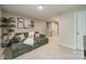 Comfortable living room with soft carpet, a large green couch and decorative wall art for added character at 5306 Graypark Dr, Charlotte, NC 28269