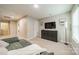 Comfortable living room with soft carpet, a large green couch and a wall-mounted TV for relaxation and entertainment at 5306 Graypark Dr, Charlotte, NC 28269