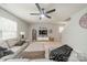 Inviting living room with a ceiling fan, TV, and decorative accents at 5306 Graypark Dr, Charlotte, NC 28269