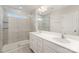 Bathroom featuring double sinks, large mirror, tiled shower, and white cabinets at 5532 Axil Ln, Charlotte, NC 28269