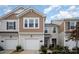 Inviting townhome featuring a one-car garage, well-maintained landscaping, and traditional architecture at 5532 Axil Ln, Charlotte, NC 28269