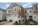 Attractive townhome showing well manicured landscaping, single-car garage, and classic design elements at 5532 Axil Ln, Charlotte, NC 28269