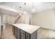 Spacious kitchen with gray cabinets, stainless steel appliances, and center island with countertop at 5532 Axil Ln, Charlotte, NC 28269