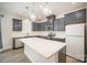 Bright kitchen featuring gray cabinets, backsplash, stainless steel appliances, and center island with white countertop at 5532 Axil Ln, Charlotte, NC 28269