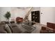 Bright living room featuring a staircase, comfortable seating, and a modern bookshelf at 5532 Axil Ln, Charlotte, NC 28269