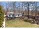 Aerial view of the property showcasing the home's layout, surrounding trees, and well-maintained lawn at 6215 Coatbridge Ln, Charlotte, NC 28212