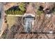 Aerial view of the property showing the house, driveway, and surrounding landscape with mature trees at 6215 Coatbridge Ln, Charlotte, NC 28212