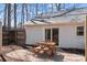 Backyard patio features a wooden dining set with pillows, offering an inviting outdoor space for entertaining at 6215 Coatbridge Ln, Charlotte, NC 28212