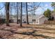 Expansive backyard view with patios, outdoor dining areas, and mature trees creating a serene outdoor retreat at 6215 Coatbridge Ln, Charlotte, NC 28212