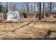 Spacious backyard features a storage shed, mature trees, and a fenced perimeter, offering privacy and functionality at 6215 Coatbridge Ln, Charlotte, NC 28212