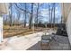 Backyard concrete patio with seating offers a relaxing outdoor space with views of the spacious, tree-filled yard at 6215 Coatbridge Ln, Charlotte, NC 28212