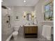 Bathroom with a shower, vanity, light fixtures, toilet, wainscoting, and mirror at 6215 Coatbridge Ln, Charlotte, NC 28212