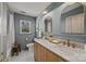 Bathroom with double sink vanity and gold hardware, marble countertops, and elegant light fixtures at 6215 Coatbridge Ln, Charlotte, NC 28212