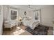 Bedroom with natural light, light-colored walls, and a plush chair with a patterned throw pillow at 6215 Coatbridge Ln, Charlotte, NC 28212