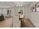 Bright dining room featuring a wood table, upholstered chairs, and a modern chandelier at 6215 Coatbridge Ln, Charlotte, NC 28212