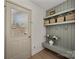 Mudroom entryway with coat rack, baskets, a bench, and a door with glass leading to the outside at 6215 Coatbridge Ln, Charlotte, NC 28212