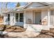 Inviting front porch of a charming brick home, with stylish chairs, and fresh landscaping at 6215 Coatbridge Ln, Charlotte, NC 28212