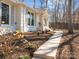 Beautifully landscaped front yard with a charming walkway leading to a well-maintained white brick home at 6215 Coatbridge Ln, Charlotte, NC 28212