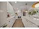 Bright kitchen with island, white cabinets, pendant lighting, stainless appliances and view to living room at 6215 Coatbridge Ln, Charlotte, NC 28212