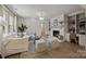 Cozy living room featuring a fireplace, comfortable seating, a decorative rug, and built-in shelving at 6215 Coatbridge Ln, Charlotte, NC 28212