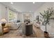 Cozy living room with neutral furniture, a patterned rug, and large windows that provide natural light at 6215 Coatbridge Ln, Charlotte, NC 28212