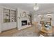 Open concept living room with a fireplace, built-in shelving, and seamless access to the kitchen at 6215 Coatbridge Ln, Charlotte, NC 28212