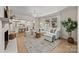 Inviting living room with fireplace, neutral decor, view to kitchen and lots of natural light at 6215 Coatbridge Ln, Charlotte, NC 28212