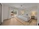 Bright main bedroom with a light rug, neutral decor and a sliding glass door leading to outdoor patio seating at 6215 Coatbridge Ln, Charlotte, NC 28212