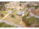 Aerial view of a brick house featuring a large backyard, a blue pool, and a detached garage at 705 Tirzah Rd, York, SC 29745