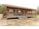 View of the covered back porch with wood railings, brick pillars, a pool deck, and an outdoor ceiling fan at 705 Tirzah Rd, York, SC 29745