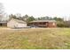 Wide shot of the home showing the backyard with a pool, detached garage, shed, and back porch at 705 Tirzah Rd, York, SC 29745