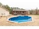 Backyard with a large rectangular in-ground pool, brick pool deck, back porch, and detached garage at 705 Tirzah Rd, York, SC 29745