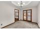 Dining area with stylish chandelier and access to a deck overlooking the backyard pool area at 705 Tirzah Rd, York, SC 29745