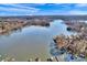 Expansive aerial view showcasing the serene lake and the surrounding natural landscape under a bright, blue sky at 7262 Right Angle St, Sherrills Ford, NC 28673