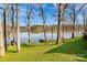 Green backyard leading to lake with private dock and tree views at 7262 Right Angle St, Sherrills Ford, NC 28673