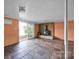 Basement living area with brick accent wall, fireplace, tile floors, and sliding door access at 7262 Right Angle St, Sherrills Ford, NC 28673