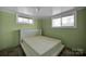 Simple bedroom with carpet flooring, brick-like textured walls, and ample light at 7262 Right Angle St, Sherrills Ford, NC 28673