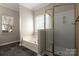 Bathroom with a soaking tub, stand up shower, and a large window at 7562 Sedgebrook W Dr, Stanley, NC 28164