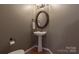 A powder room featuring an oval mirror and hardwood flooring at 7562 Sedgebrook W Dr, Stanley, NC 28164