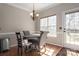 A dining area with natural light, a modern chandelier, and hardwood floors at 7562 Sedgebrook W Dr, Stanley, NC 28164