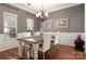 Elegant dining room with wood floors, a rustic table, and decorative accents creating a warm ambiance at 7562 Sedgebrook W Dr, Stanley, NC 28164