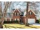 Attractive brick home with well-maintained landscaping, featuring a two-car garage and a welcoming entrance at 7562 Sedgebrook W Dr, Stanley, NC 28164